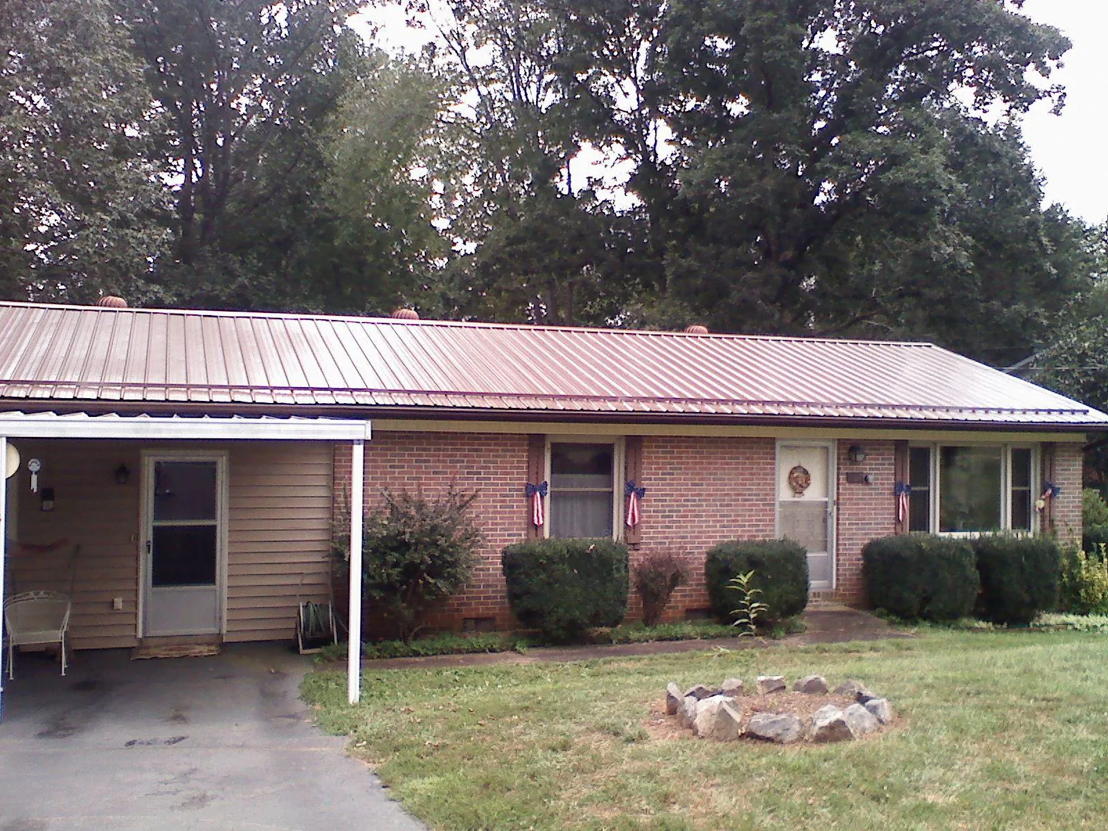 Bronze metal roof and carport on a brick ranch home — Roof Repair work by our crew in Parsippany